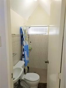 a bathroom with a toilet and a sink at Homestay at 24 Laguna Bel-Air by Red Door House Rental in Santa Rosa