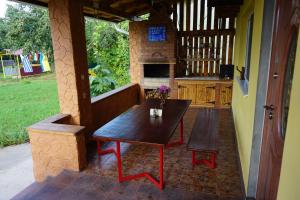 a patio with a wooden table and a table and bench at Red Star Peoples Republic in Tiraspol