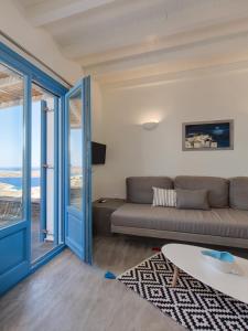 a living room with a couch and a table at Serifos Blue in Rámos