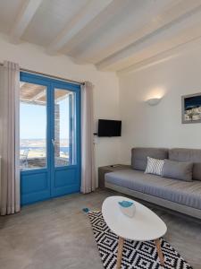 a living room with a couch and a table at Serifos Blue in Rámos