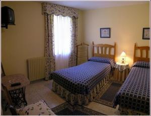 Postel nebo postele na pokoji v ubytování Hotel Toscana