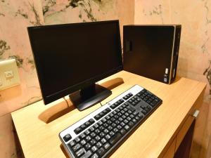 a computer monitor and a keyboard on a desk at Hotel Pearl City Sapporo in Sapporo