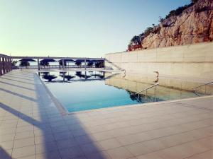a pool of water with a bridge in the background at Mobile home Lučan in Drage