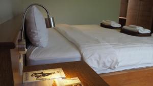 a bedroom with a bed with a lamp on a table at Crystal Lamai Hotel in Lamai