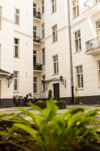 a large white building with bikes parked in front of it at Okolnik Apartment in Warsaw