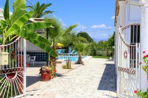a gate to a house with a swimming pool at Crystal in Kavos