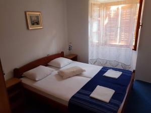 a bedroom with a bed with two towels on it at Vila Sipan in Šipanska Luka