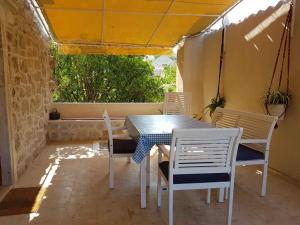 a table and chairs on a patio with a tent at Vila Sipan in Šipanska Luka