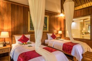 Tempat tidur dalam kamar di Ananda Ubud Resort