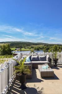 a patio with a couch and a table on a balcony at Kongsvinger Budget Hotel in Kongsvinger