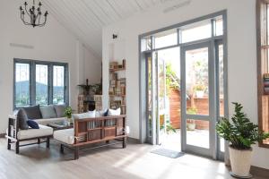 a living room with a couch and a table at Tia Du Villa Homestay in Da Lat