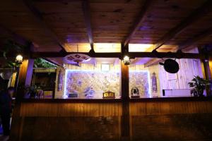 a bar with a stone wall with lights on it at Dai Yuan Inn in Mengla +104 photos