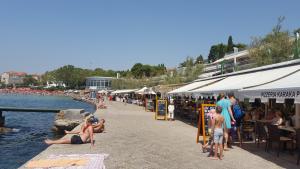 a group of people on a beach near the water at Apartment Maka in Split