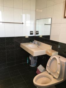 a bathroom with a toilet and a sink at manor in Houli