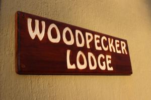 a sign on a wall that reads woodspeaker lodge at Woodpecker Lodge B&B in Hoedspruit