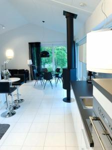 a kitchen and living room with a stove at Villa Vihti in Ojakkala