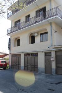um edifício com duas portas de garagem em frente em Hotel For You em Yerevan