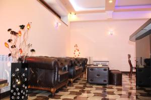 a waiting room with leather couches and a fireplace at Hotel For You in Yerevan