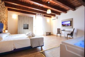 a hotel room with two beds and a television at Double B Maison De Charme in Alghero