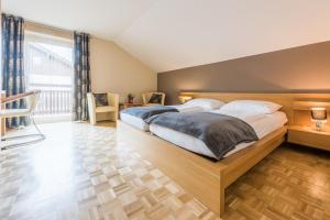 a bedroom with a large bed and a large window at Almliesl MAIS-428 in Maishofen