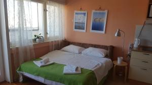 a bedroom with a bed with towels on it at Apartment Maka in Split