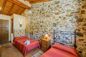 Ένα ή περισσότερα κρεβάτια σε δωμάτιο στο "El Porton" (El Borge ,Malaga).