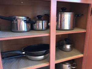 a row of pots and pans on a shelf at Downtown Condo with a View Sleeps 4 5D in Atlanta