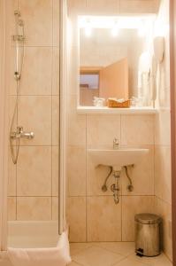 
a bathroom with a shower, sink, and tub at Hotel Petka in Dubrovnik
