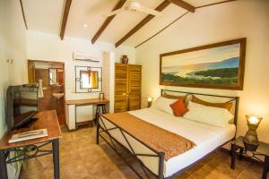 Uma cama ou camas num quarto em Conchal Hotel