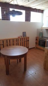 a kitchen with a wooden table in a room at Järva Jahindusklubi HOSTEL in Paide