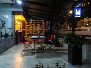 a restaurant with chairs and a table in a room at Hotel Metro 26 in Bogotá