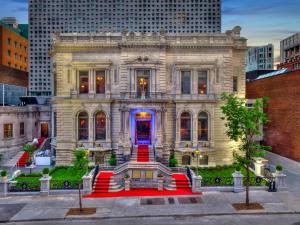 an old building with red stairs in a city at Le Mount Stephen in Montreal