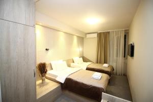 Postel nebo postele na pokoji v ubytování Garni Hotel Mlinarev san