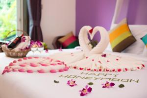 a birthday cake with two swans on a table at Tan Kang Angkor Hotel in Siem Reap +83 photos