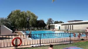 a large swimming pool with people in it at Casa Rural Sierra de Huelva in Aroche
