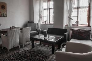 a living room with chairs and a coffee table at Penzion-apartmán U Johana in Moravská Třebová