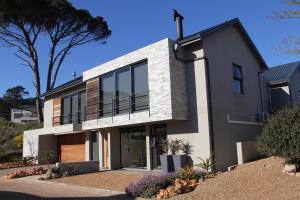 a modern house with black and white at 22 on Gabbro in Somerset West