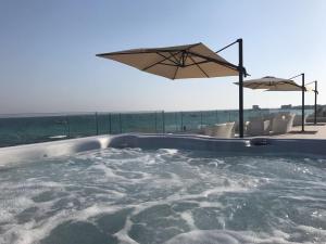 a hot tub with a view of the ocean at Bahiamar in Torre Lapillo