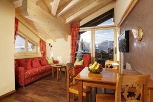 a living room with a red couch and a table at Bergidyll in Oberstdorf