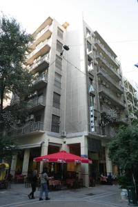 a large building with a red umbrella in front of it at Alma in Athens