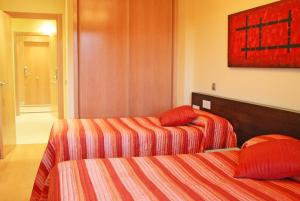 Posteľ alebo postele v izbe v ubytovaní Apartahotel Ribera