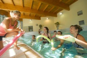 a group of people in a pool playing with frisbees at VTF Le Bief Rouge in Métabief