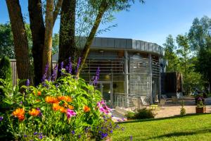 a building with flowers in front of it at VTF Le Bief Rouge in Métabief