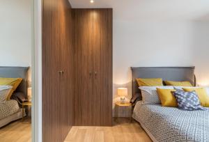 a bedroom with a bed and a wooden closet at Le Semiramis in Saint-Tropez