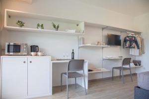 a small kitchen with a table and chairs in a room at Villa La Rosa B&B in Bellagio