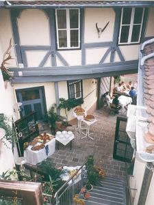 an outside view of a house with people sitting on a patio at Hotel Gasthof Krone in Lohr am Main