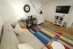a living room with a couch and a television at Tailor Apartment in the Center in Budapest