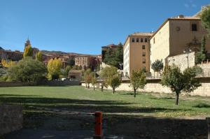 a park with trees and buildings in a city at Hotel Arabia in Albarracín