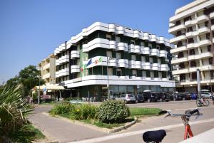 a bike parked in front of a building at Hotel Splendid Suisse in Bellaria-Igea Marina