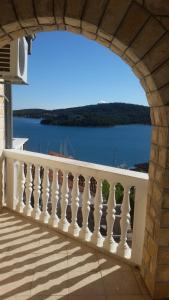 a balcony with a view of the water at Apartmani Frkic in Tisno